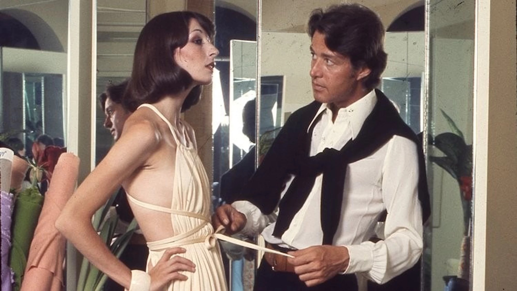 Halston dresses a model