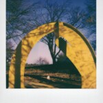 Color Polaroid of a yellow sculpture outside